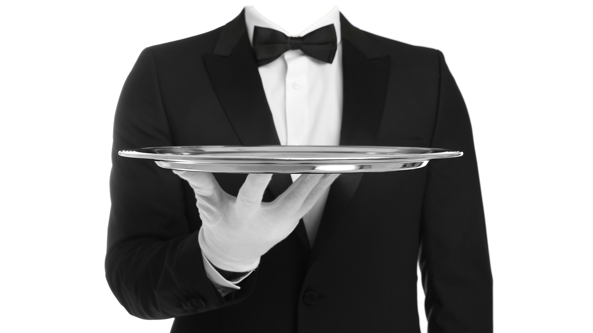 Butler facing forward dressed in formal attire holding an empty trey